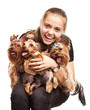 Cute young girl holding Yorkshire terrier dogs on her lap