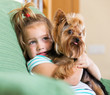 Female child playing with Yorkie